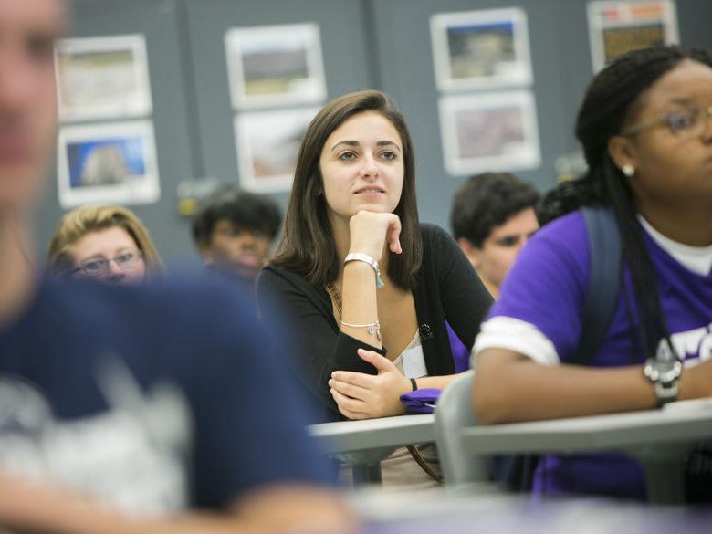 student in class listening to professor